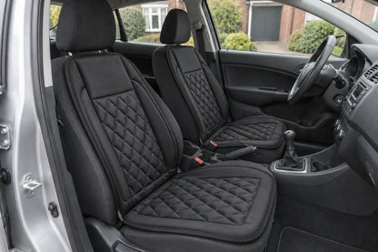 Illustrative view of two black Heat Seat covers fitted to the front seats of a right-hand-drive car