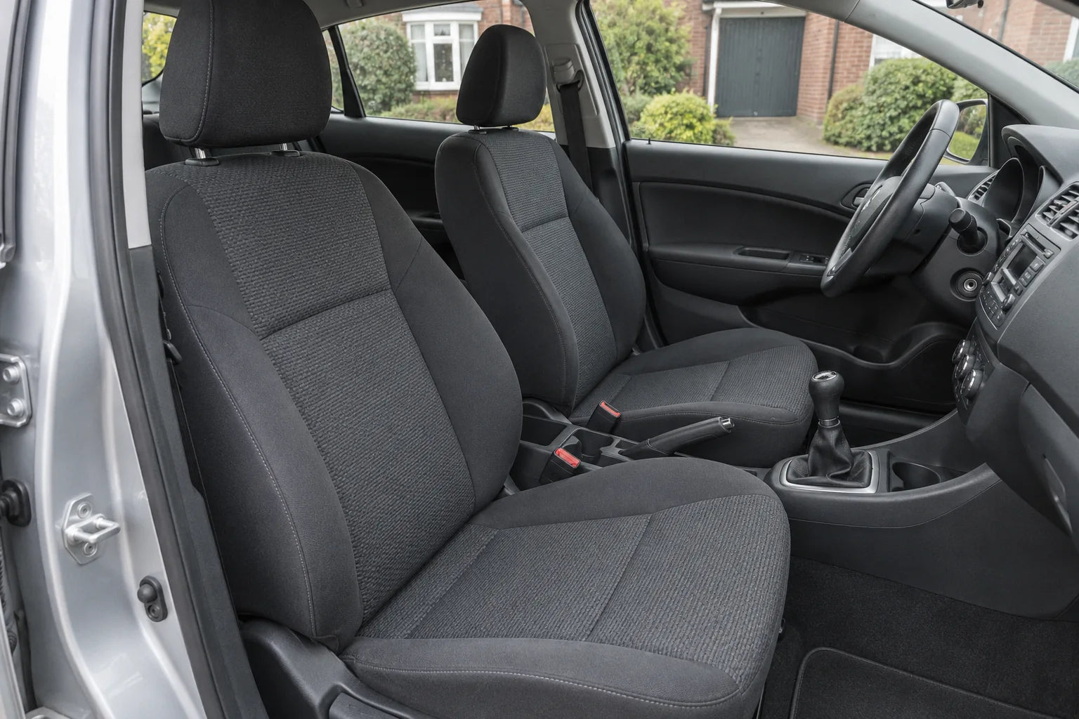 Front seats of a right-hand-drive hatchback before Heat Seat covers are fitted
